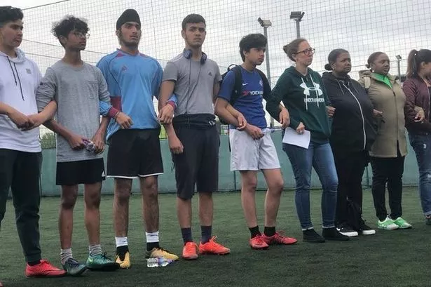 Young footballers link arms and hold poignant minute’s silence for capital's violent crime victims